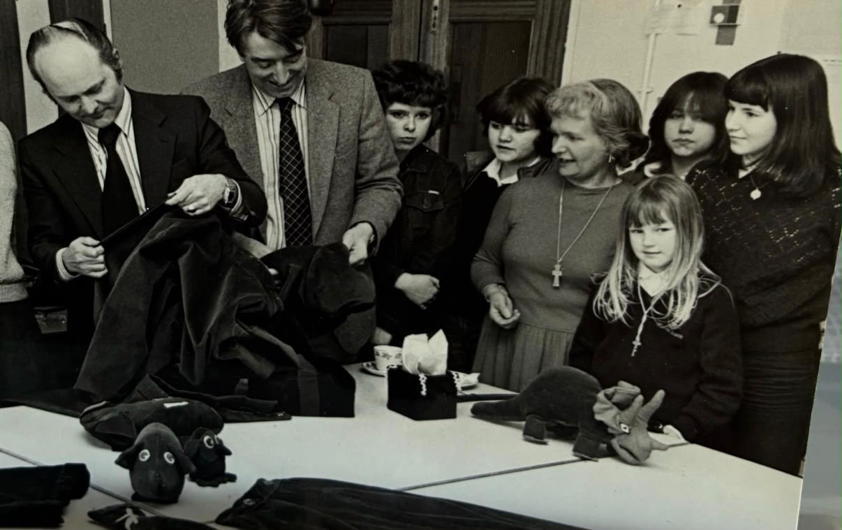 Sally in her textiles classroom with students and visitors